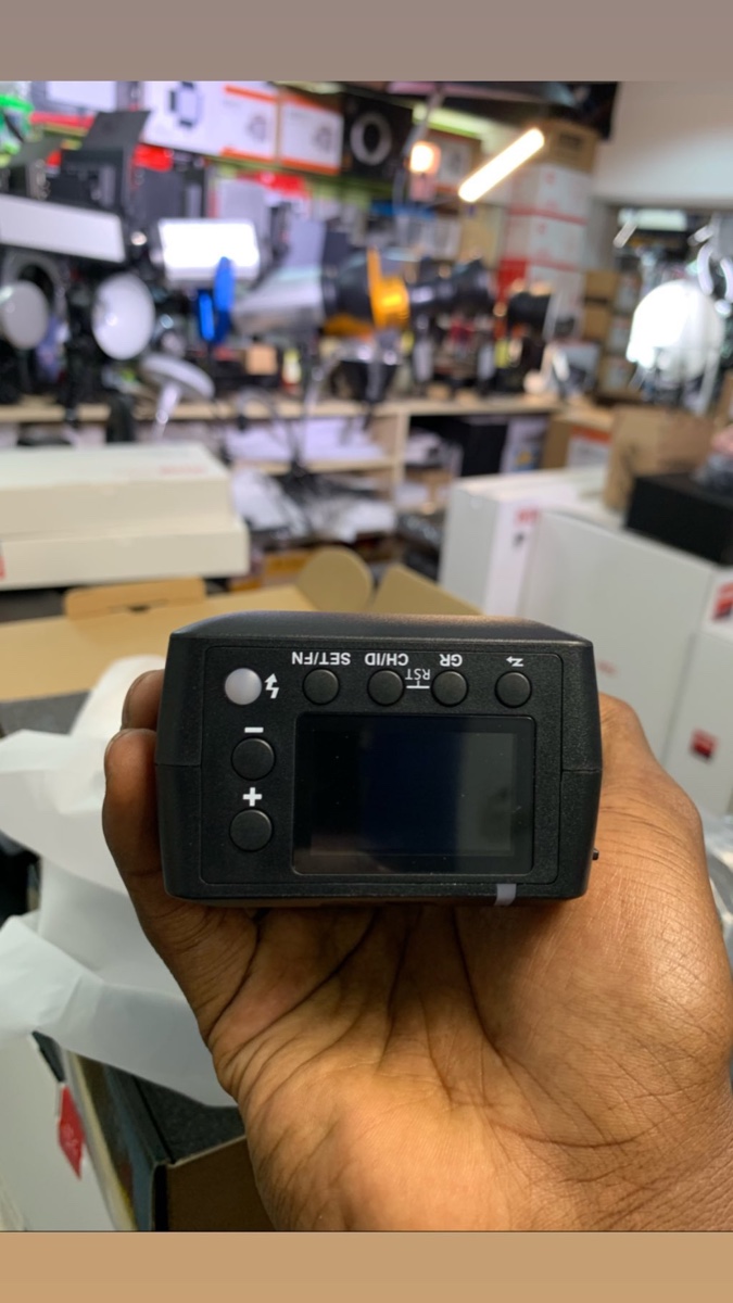 The Camera Hub counter at Kooki Tower, stock shelves behind